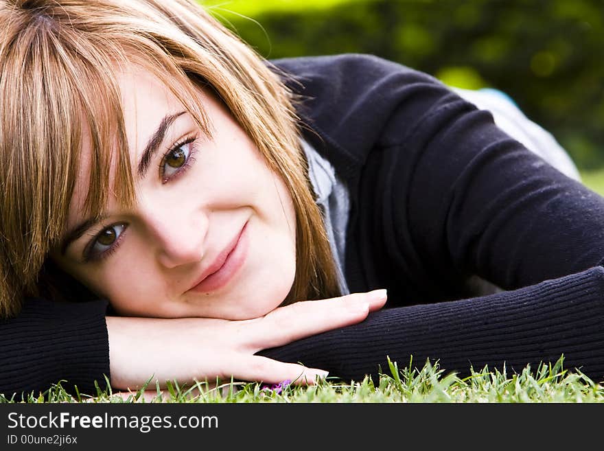 Smiling beauty on grass