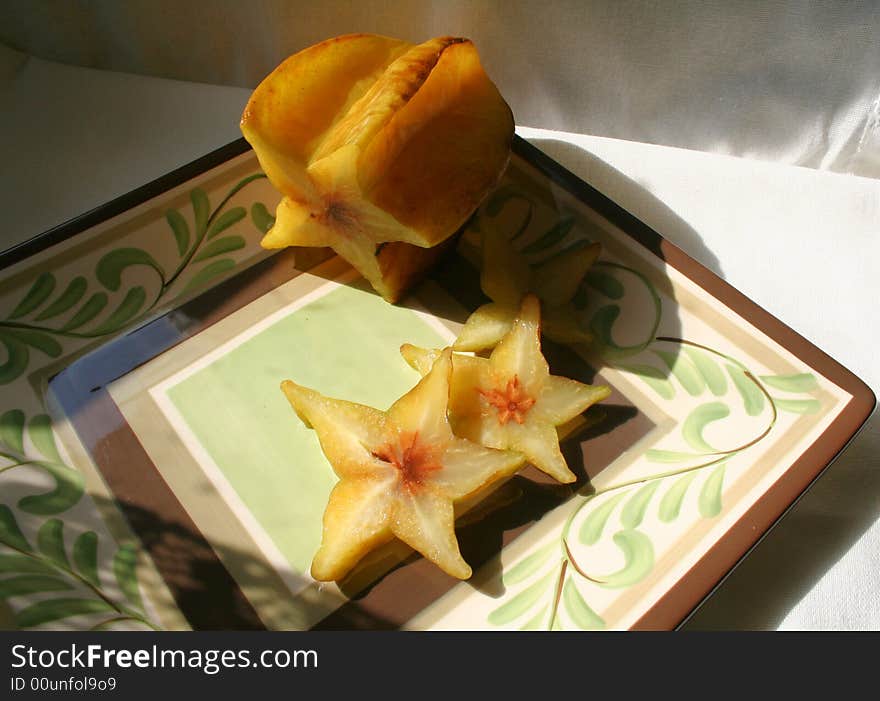 Star fruit on decorated plate. Star fruit on decorated plate.