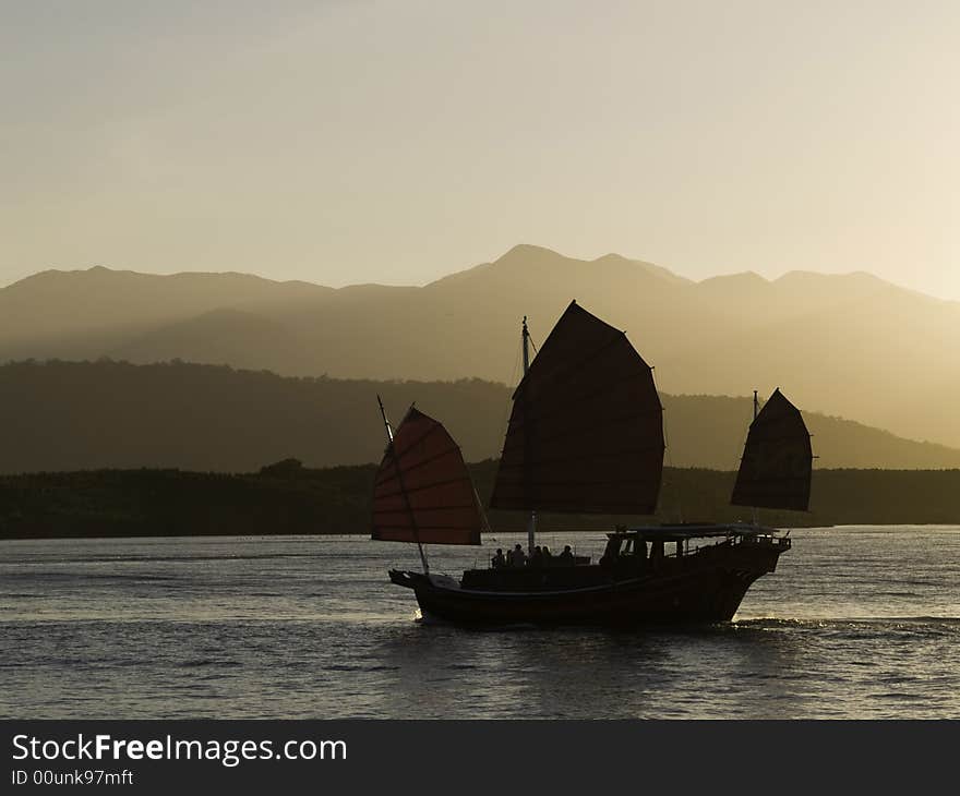 An oriental sunset cruise coming back into port. An oriental sunset cruise coming back into port.