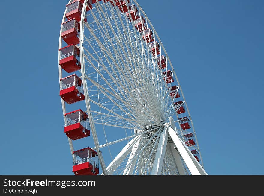 A huge red and white ferris wheel