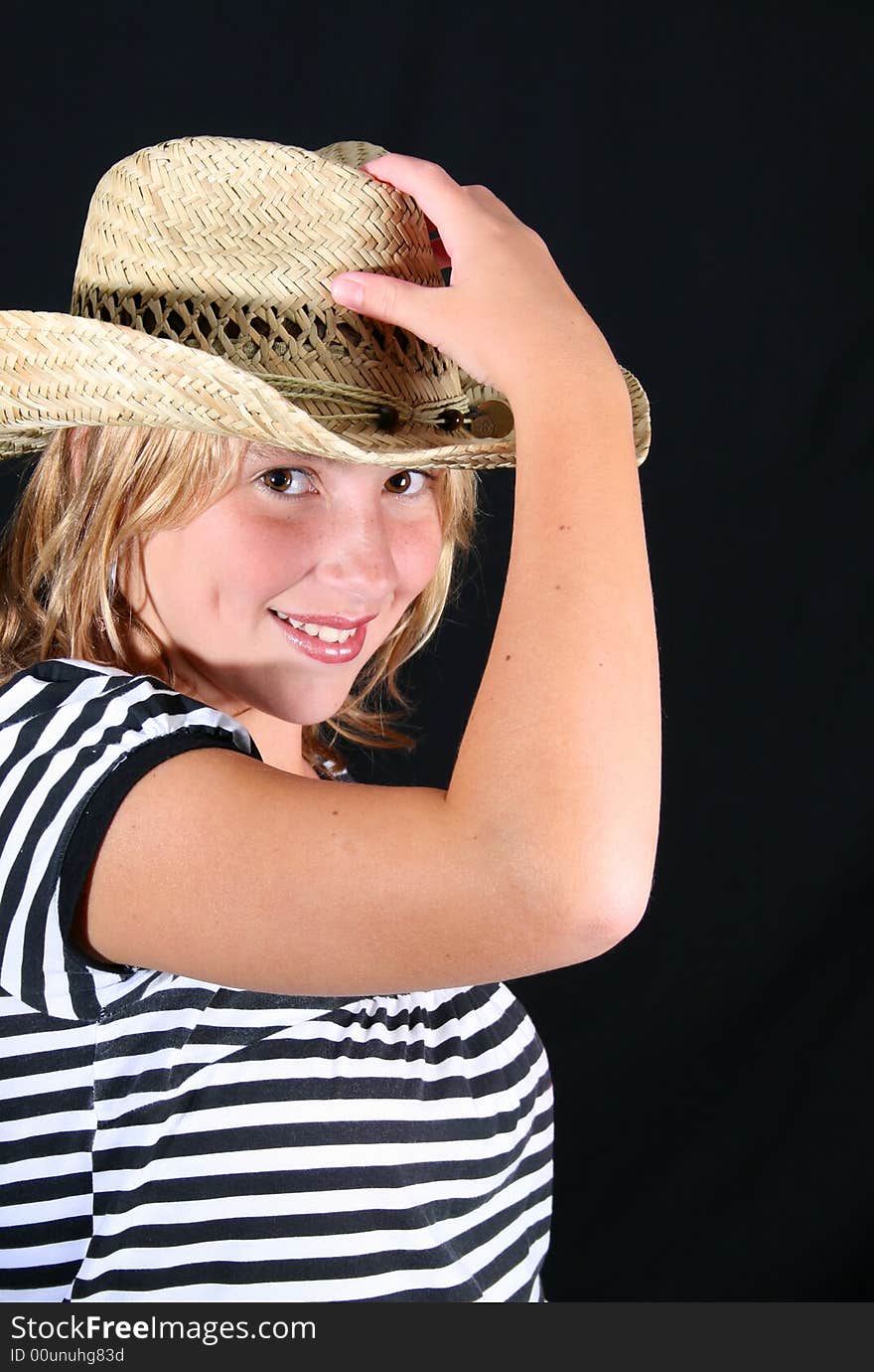 Teenage girl wearing a straw hat with a stripy top. Teenage girl wearing a straw hat with a stripy top