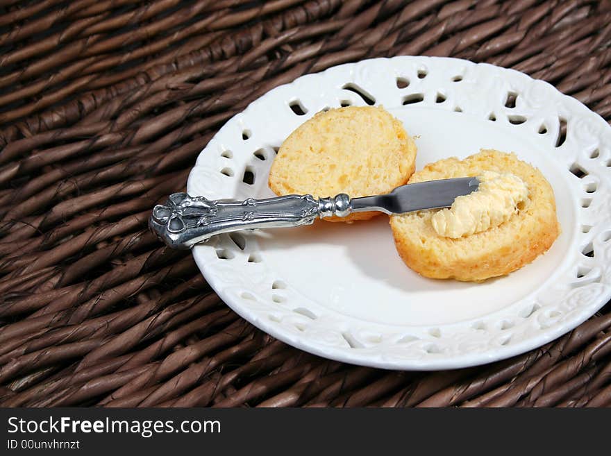 Early Moring Scones with butter on a white plate. Early Moring Scones with butter on a white plate