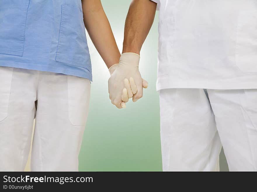 Doctor and nurse holding hands in the hospital. Doctor and nurse holding hands in the hospital