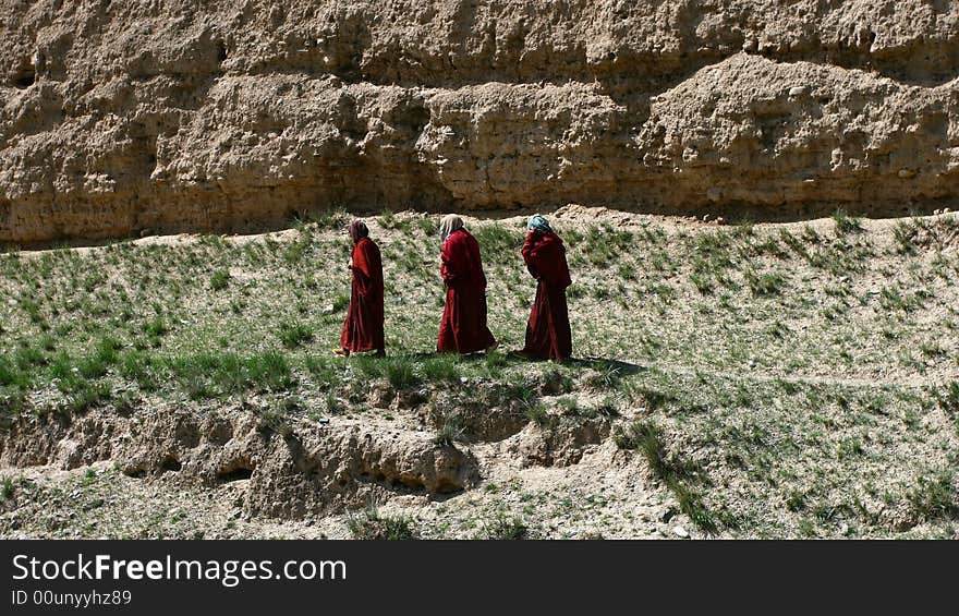 Three lamas are walking, taken from Tibet, China.