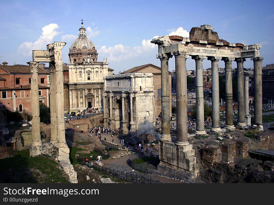 A view of the roman ruins in the crowded streets of rome. A view of the roman ruins in the crowded streets of rome