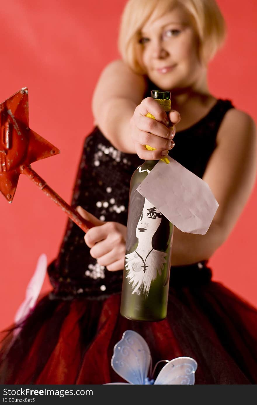 Girl hold hand-made bottle with blank label. Focus on the bottle.