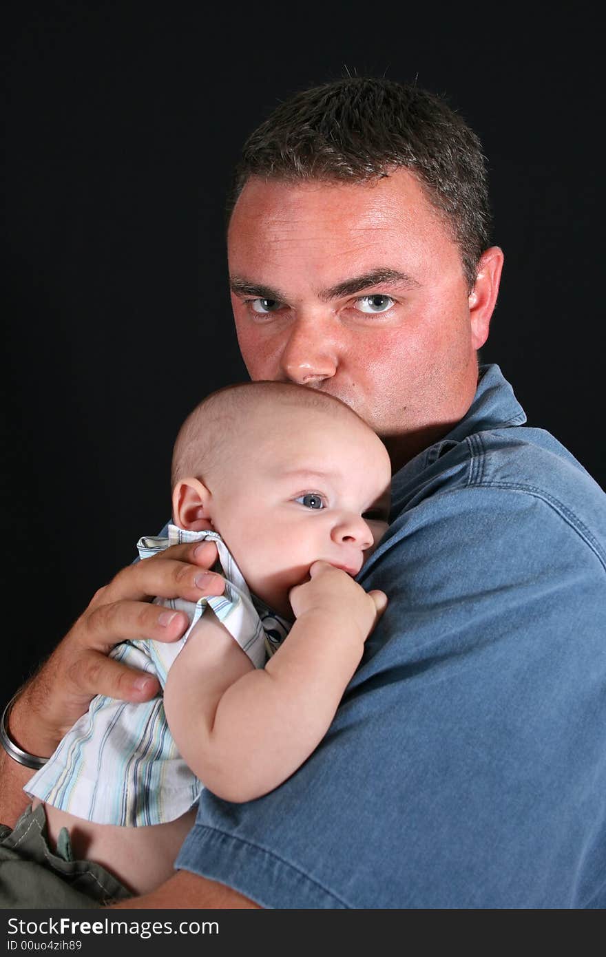 Father and Baby boy on a black background. Father and Baby boy on a black background