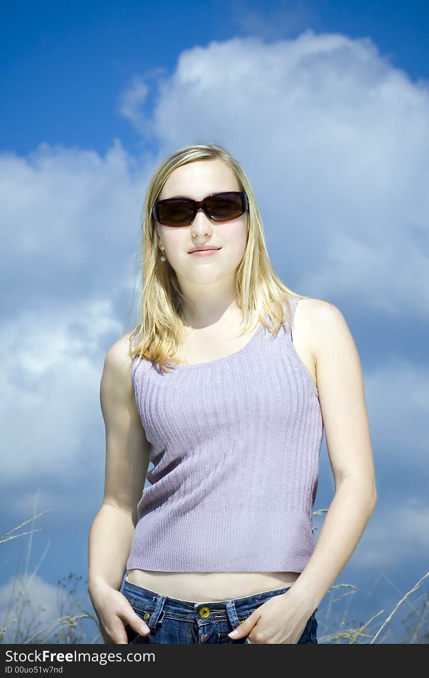 Young woman against the blue sky. Young woman against the blue sky