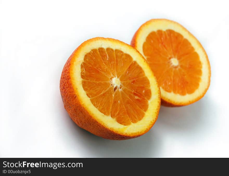 Colored slices of orange with rough surface pattern isolated on white with shadows. Colored slices of orange with rough surface pattern isolated on white with shadows