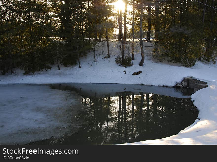 The afternoon sun lights up an icy pool and the snowbank in the foreground. The afternoon sun lights up an icy pool and the snowbank in the foreground.