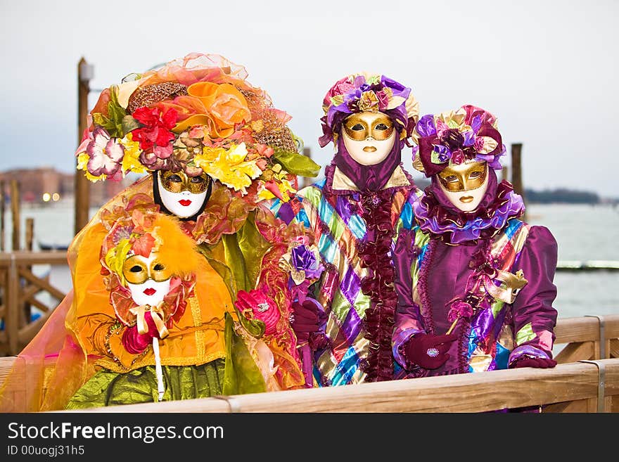 Three people in costume at the Venice Carnival. Three people in costume at the Venice Carnival