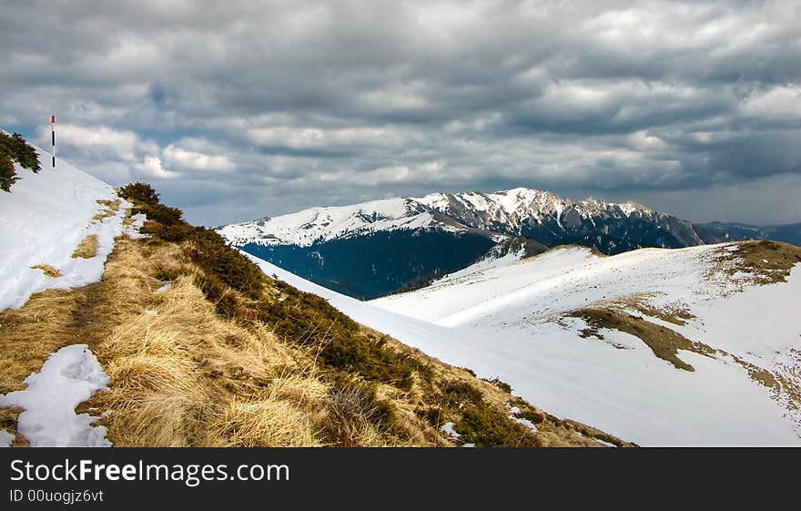 Footpath in Ciucas mountains (from Bratocea pass (1265 m) to Ciucas Peak (1954 m) you follow the red line sign. In background you can see Zaganu ridge (1883 m altitude). Footpath in Ciucas mountains (from Bratocea pass (1265 m) to Ciucas Peak (1954 m) you follow the red line sign. In background you can see Zaganu ridge (1883 m altitude)