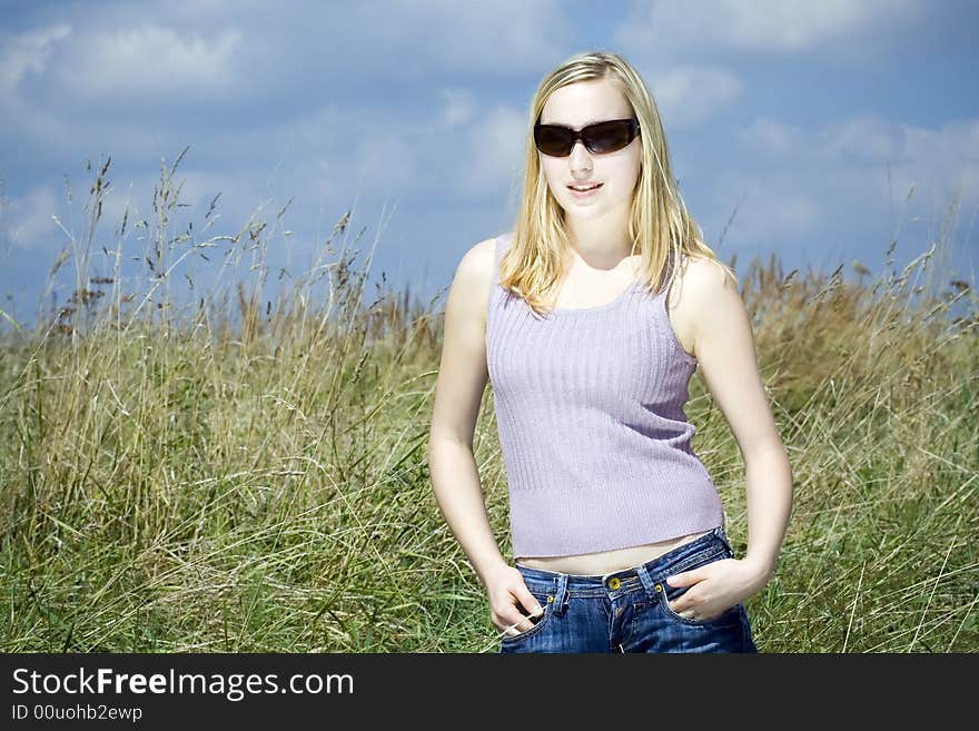 Young woman against the blue sky. Young woman against the blue sky