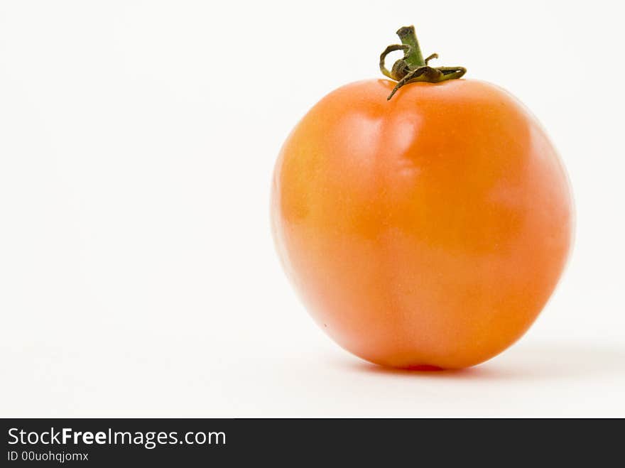 Ripe tomato on white background, shallow DOF