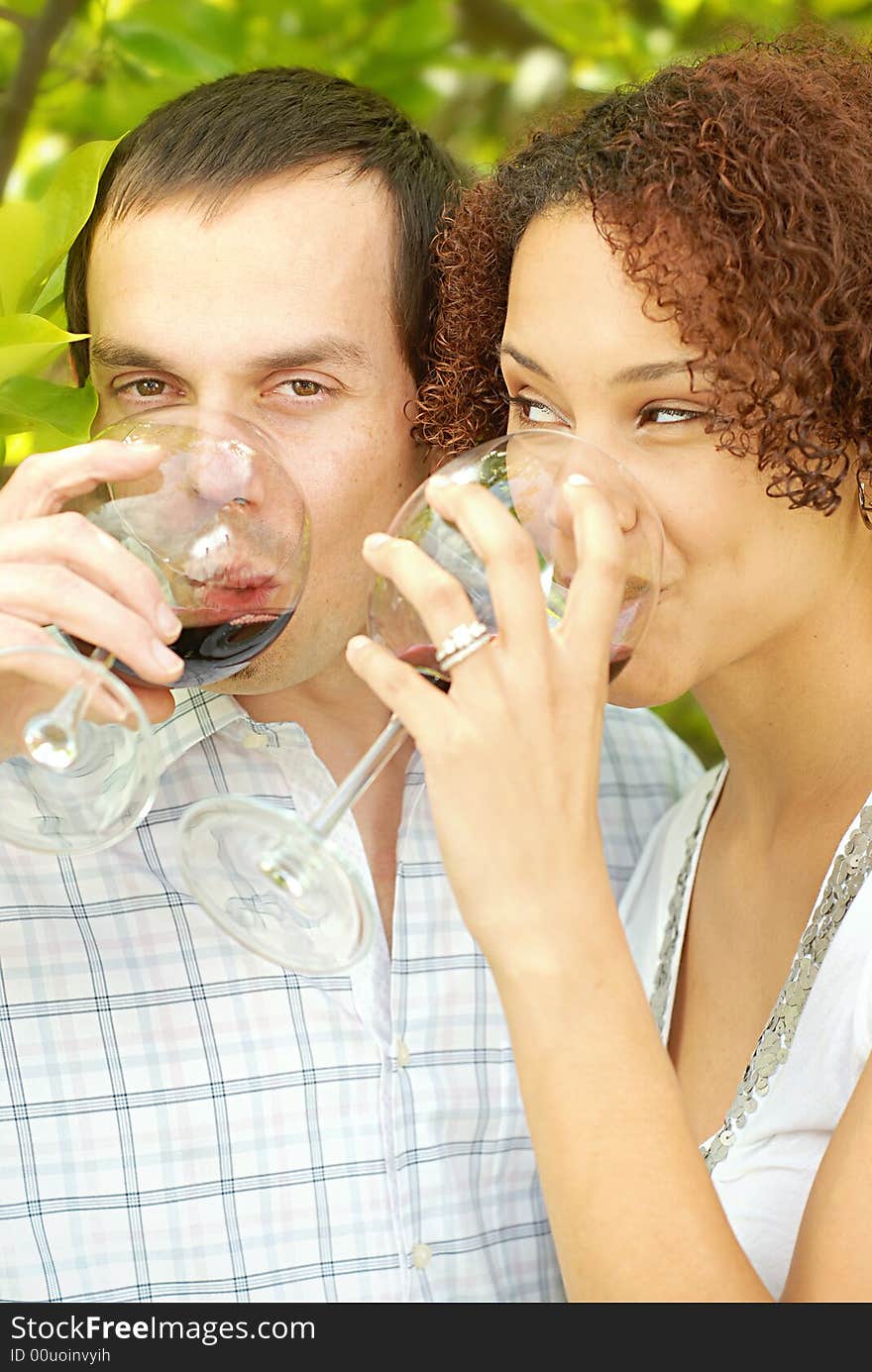 Very attractive young couple enjoying a glass of wine outdoors. Very attractive young couple enjoying a glass of wine outdoors