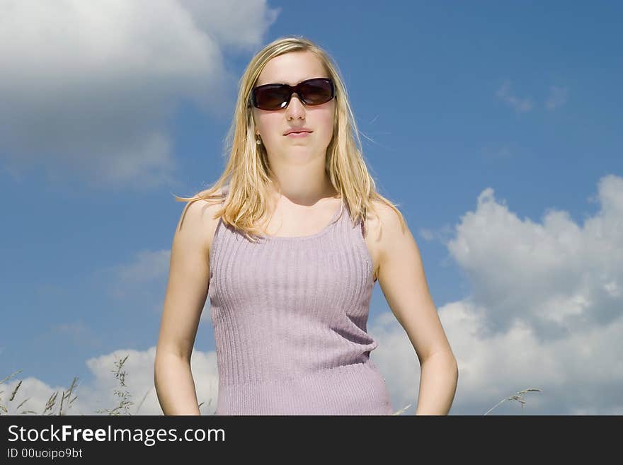 Young woman against the blue sky. Young woman against the blue sky