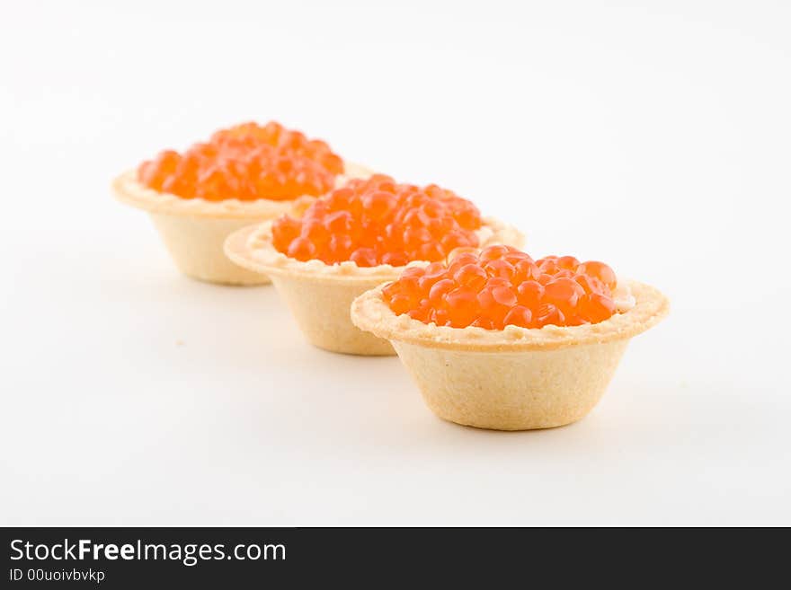 Tartlets with red caviar isolated on a white background. Tartlets with red caviar isolated on a white background