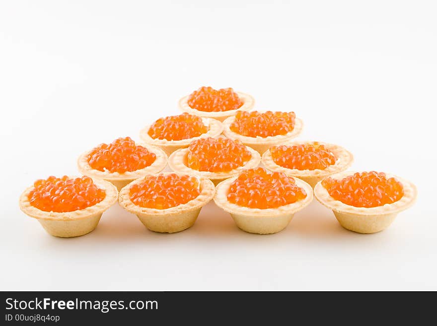 Tartlets with red caviar isolated on a white background. Tartlets with red caviar isolated on a white background