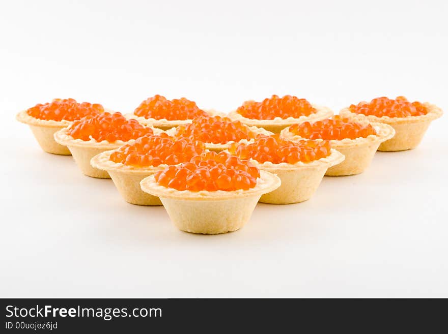 Tartlets with red caviar isolated on a white background. Tartlets with red caviar isolated on a white background