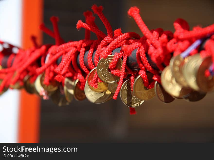 Red rope and coin,which in a temple in tokyo japan