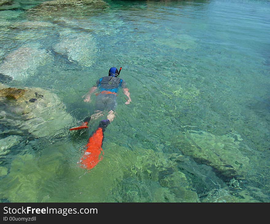 Man snorkeling in crystal azure water. Man snorkeling in crystal azure water