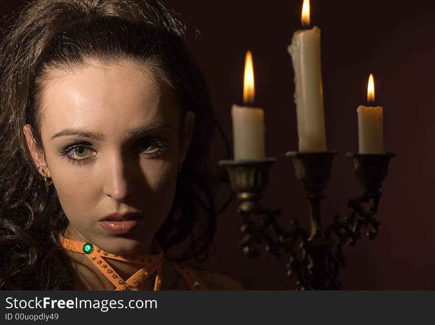 The girl with candles on a dark background