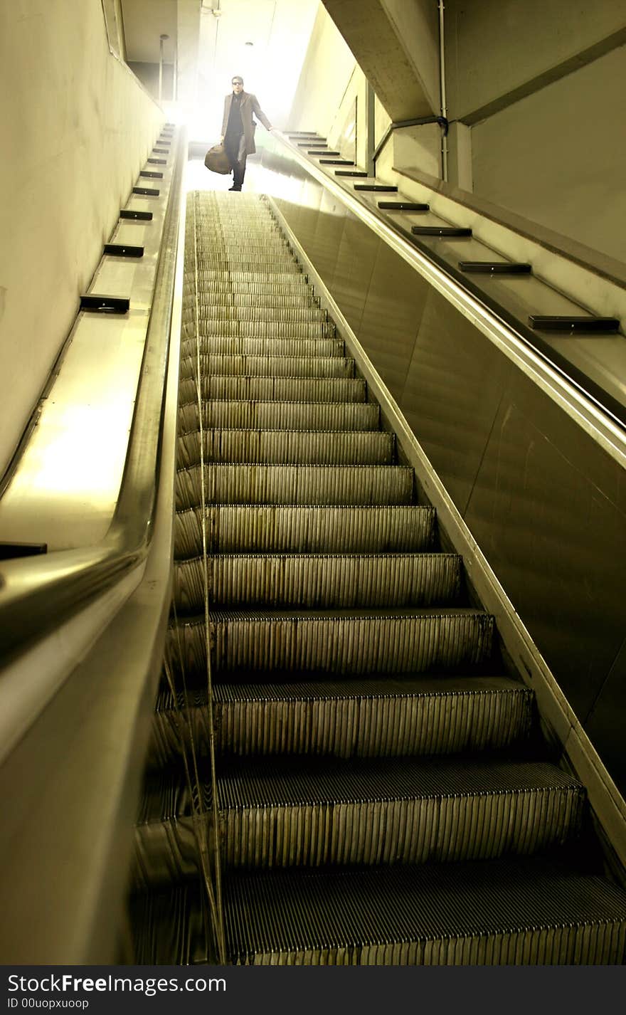 A escalator and a man. A escalator and a man