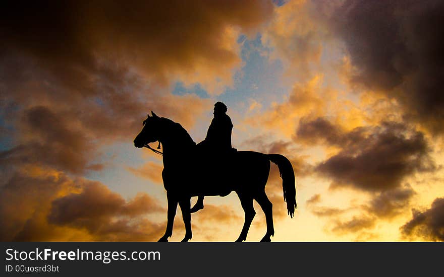 A silhouette of a statue on a sky at dusk backround. A silhouette of a statue on a sky at dusk backround