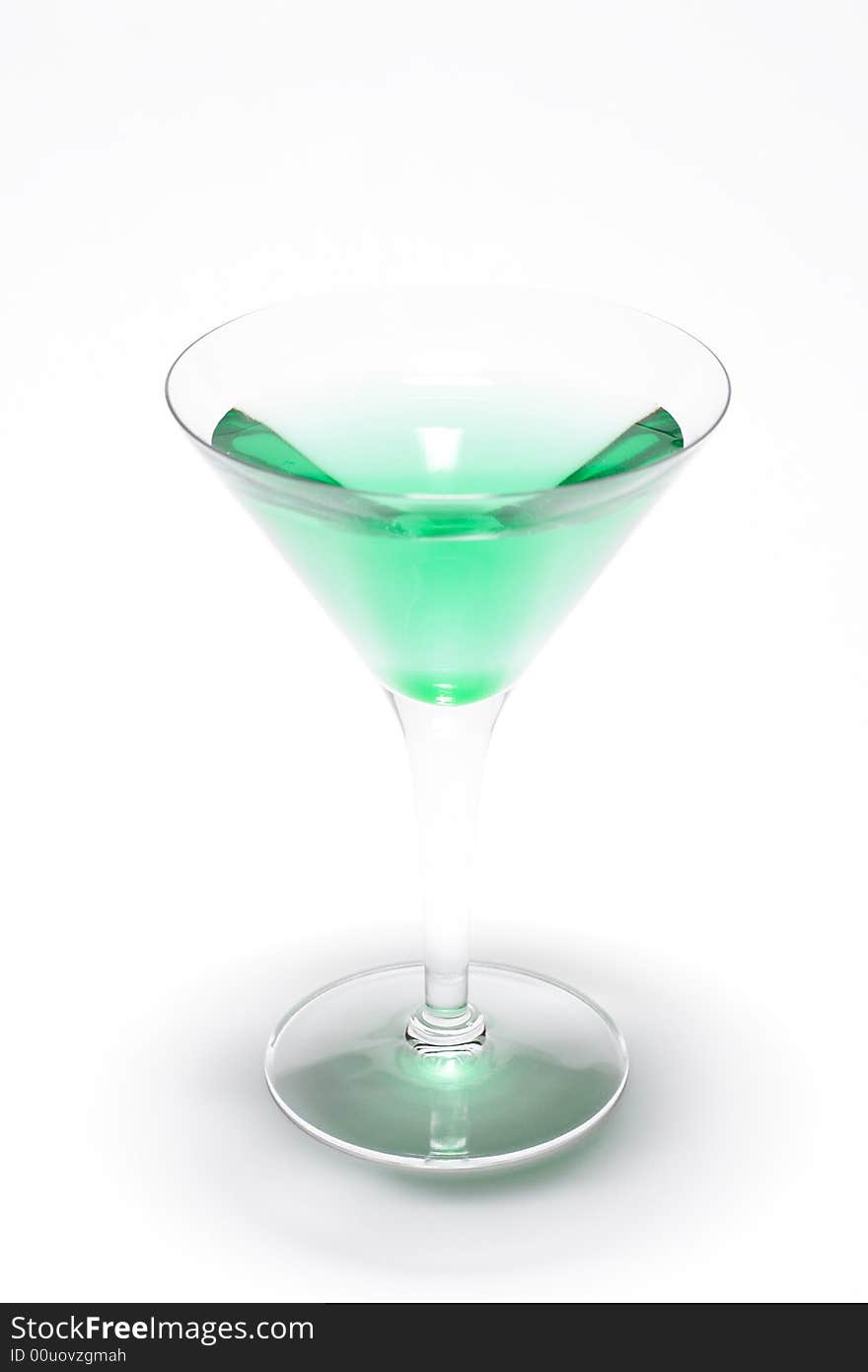 A glass with a green liquid, mint, inside. A glass with a green liquid, mint, inside.