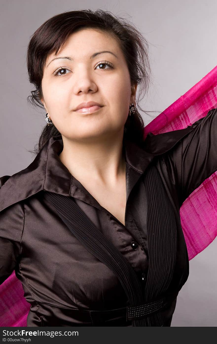 Multi-ethnic girl in studio on grey background.