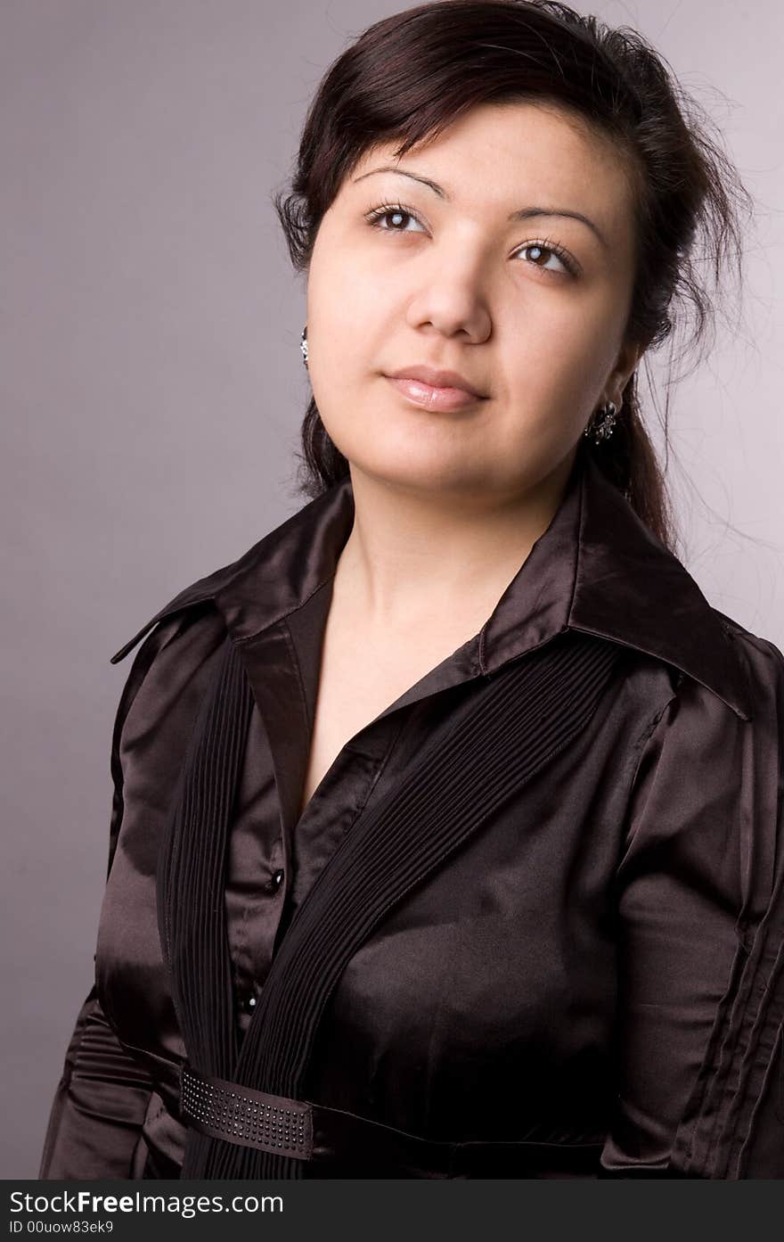 Multi-ethnic girl in studio on grey background.