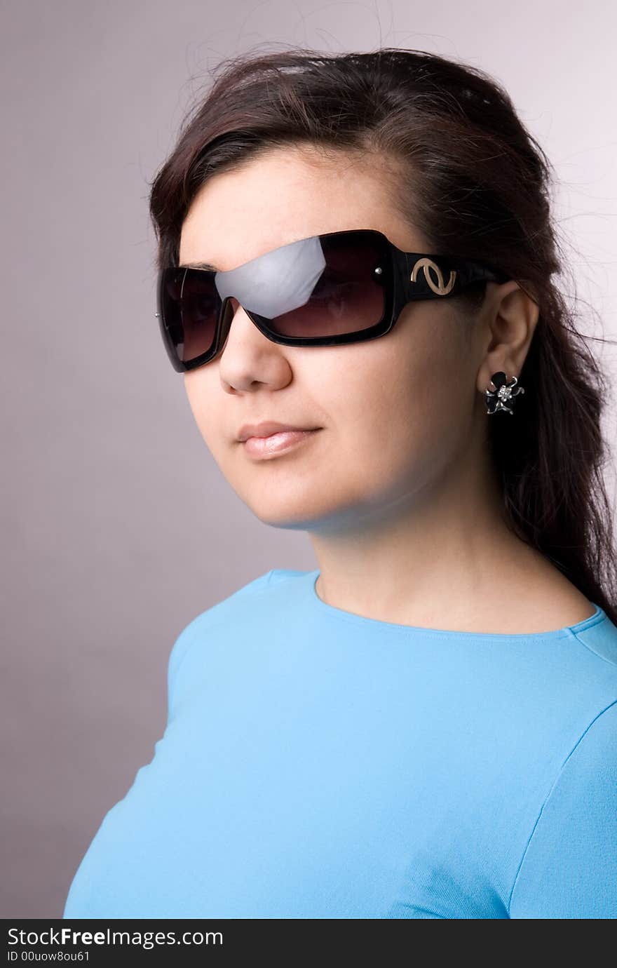 Multi-ethnic girl in studio on grey background.