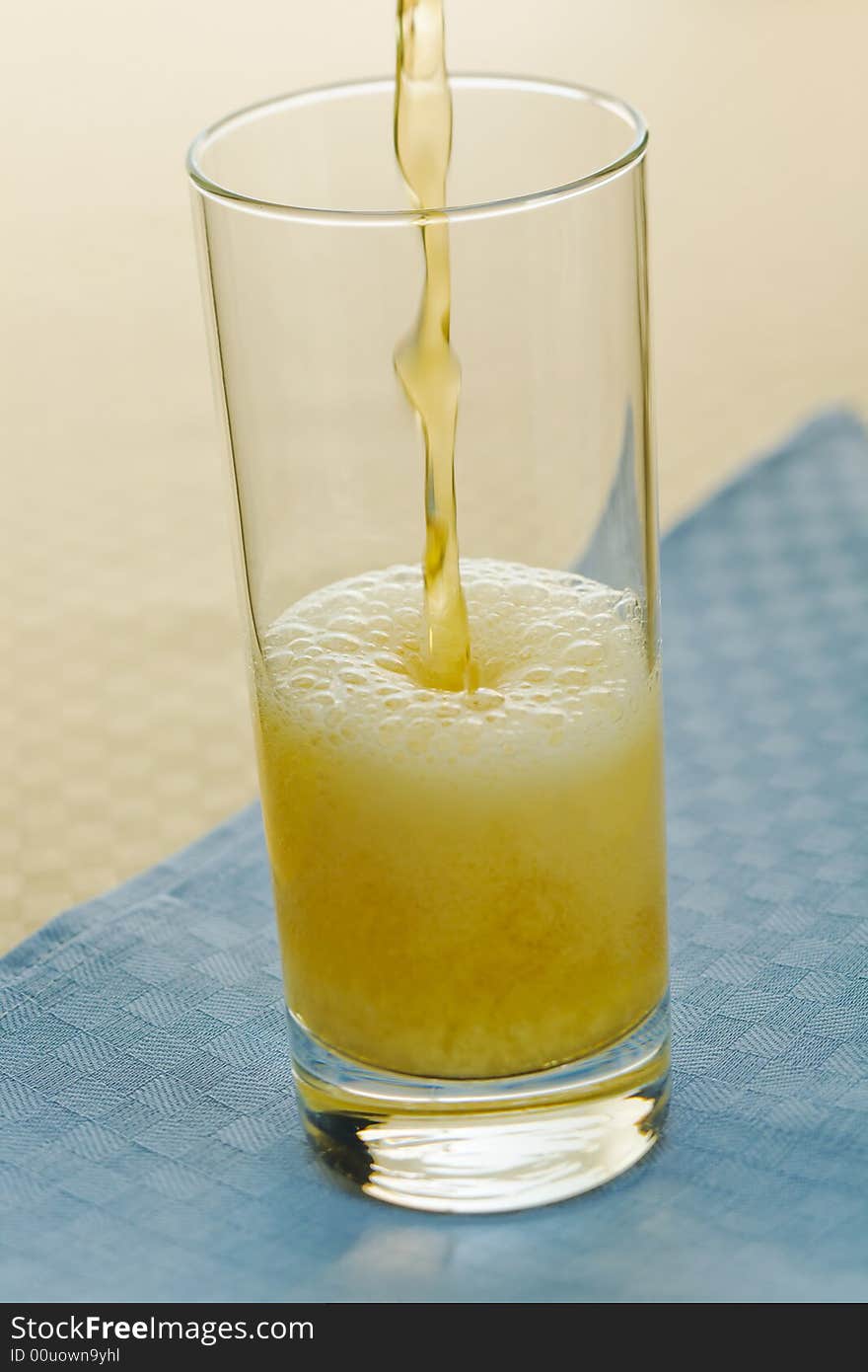 Pouring beer into glass on the table