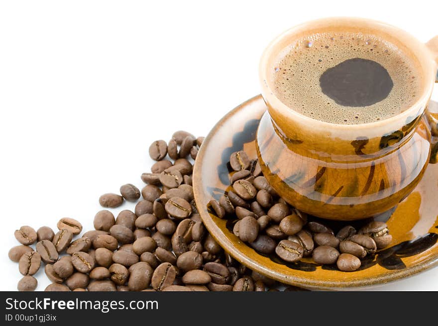 Coffee beans and black coffee in a cup