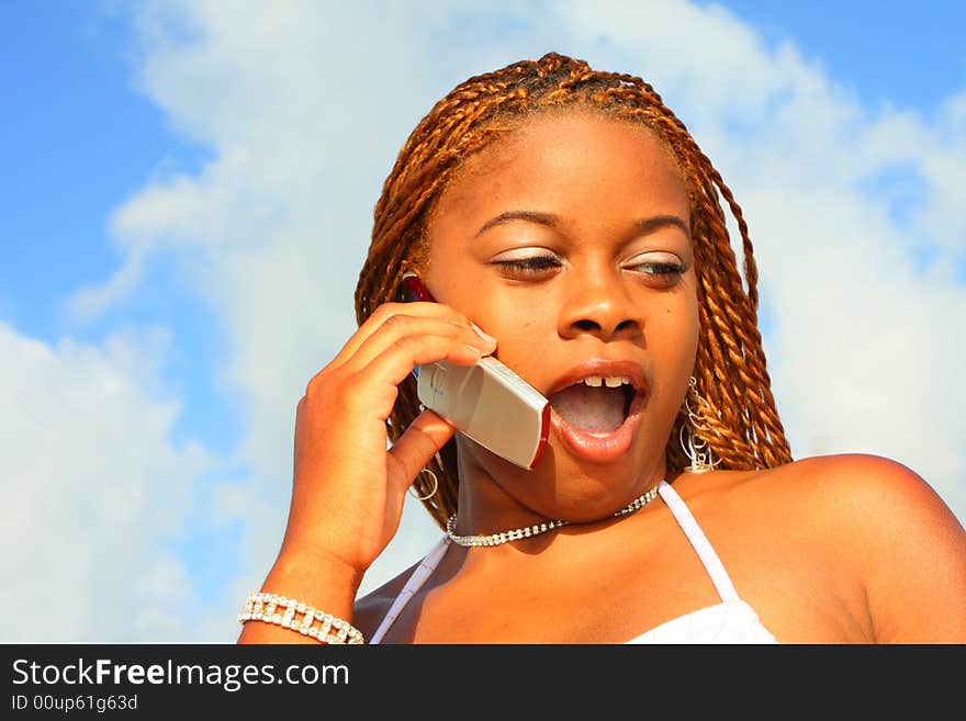 Woman on the phone expressing a shocked look. Woman on the phone expressing a shocked look