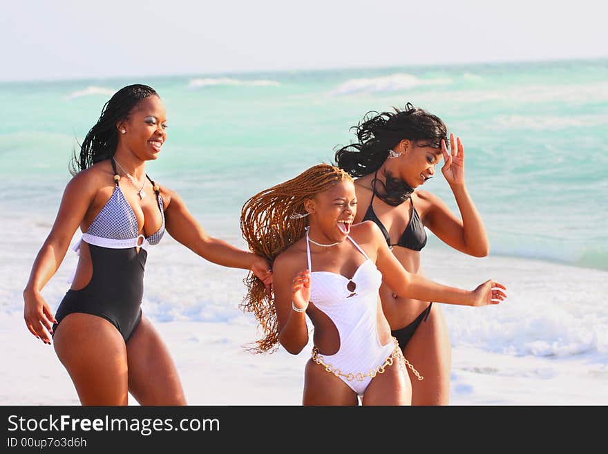 Three friends playing around on the beach. Three friends playing around on the beach