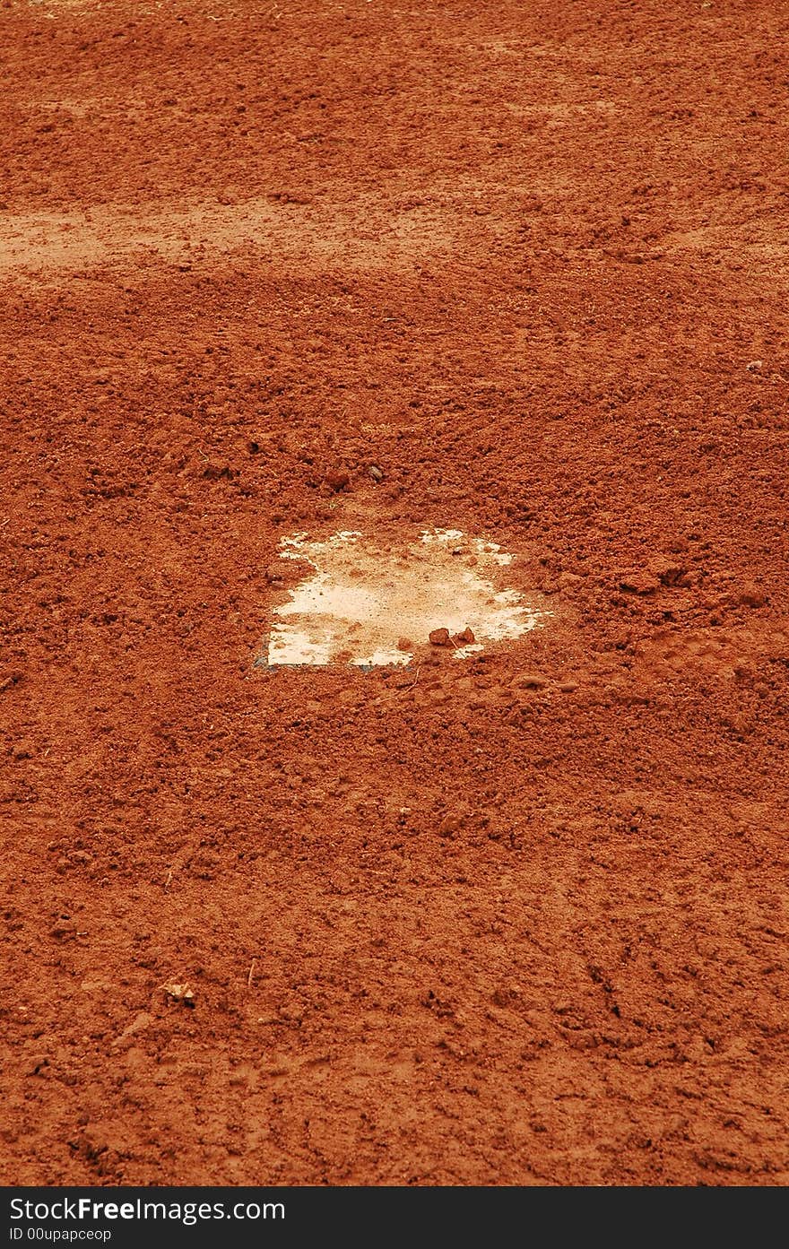 This is a photo of a home plate needing to be dust off.