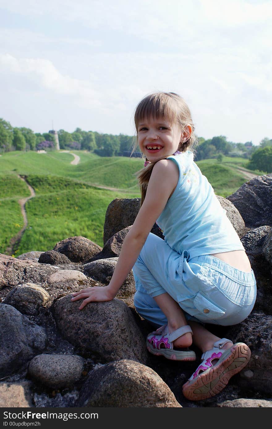 Girl seats on a rock enjoying the panorama. Girl seats on a rock enjoying the panorama