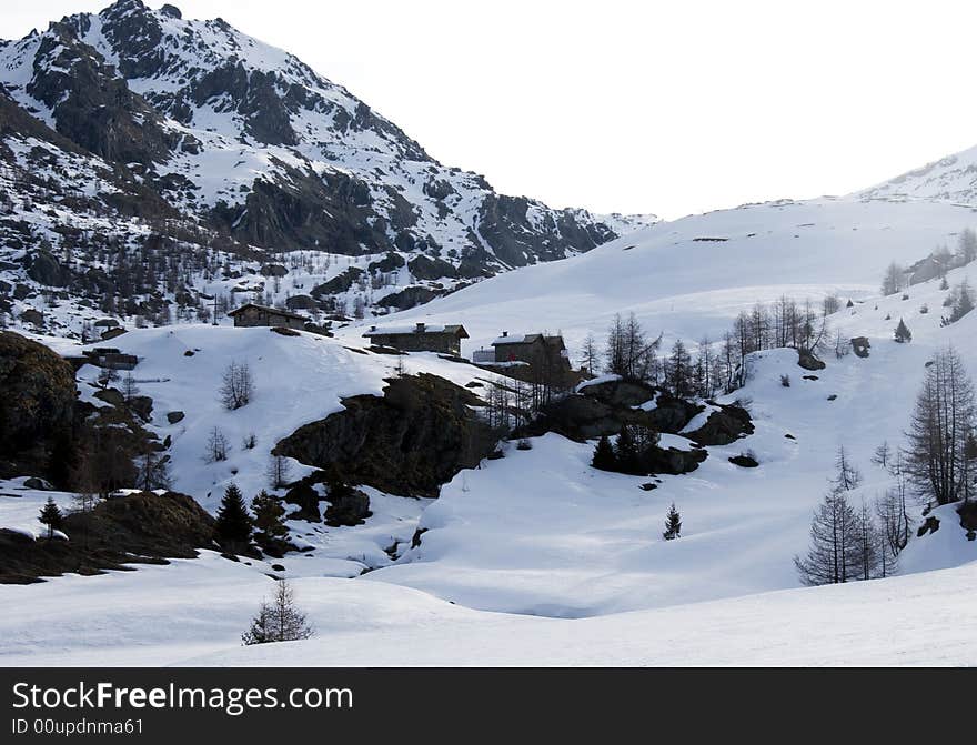 Mountain Huts Under Snow