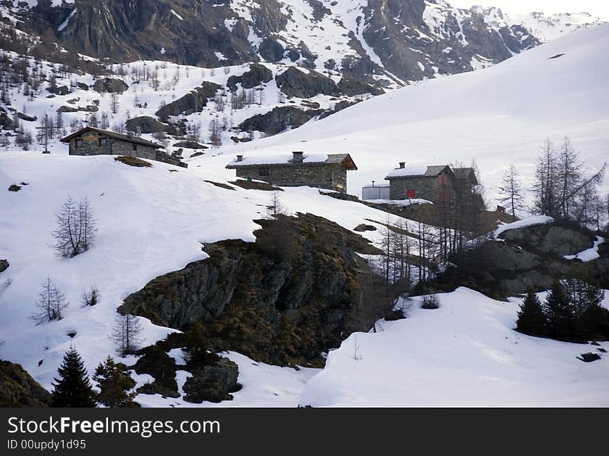 Mountain huts under snow