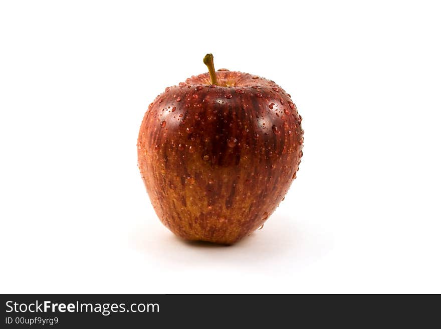 Red apple with drops isolated on white. Red apple with drops isolated on white