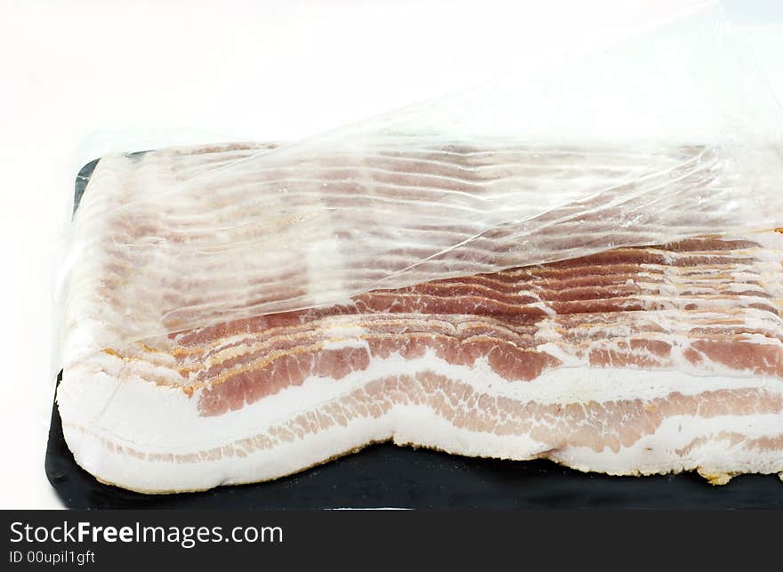 Slices of bacon in a plastic pack. Slices of bacon in a plastic pack