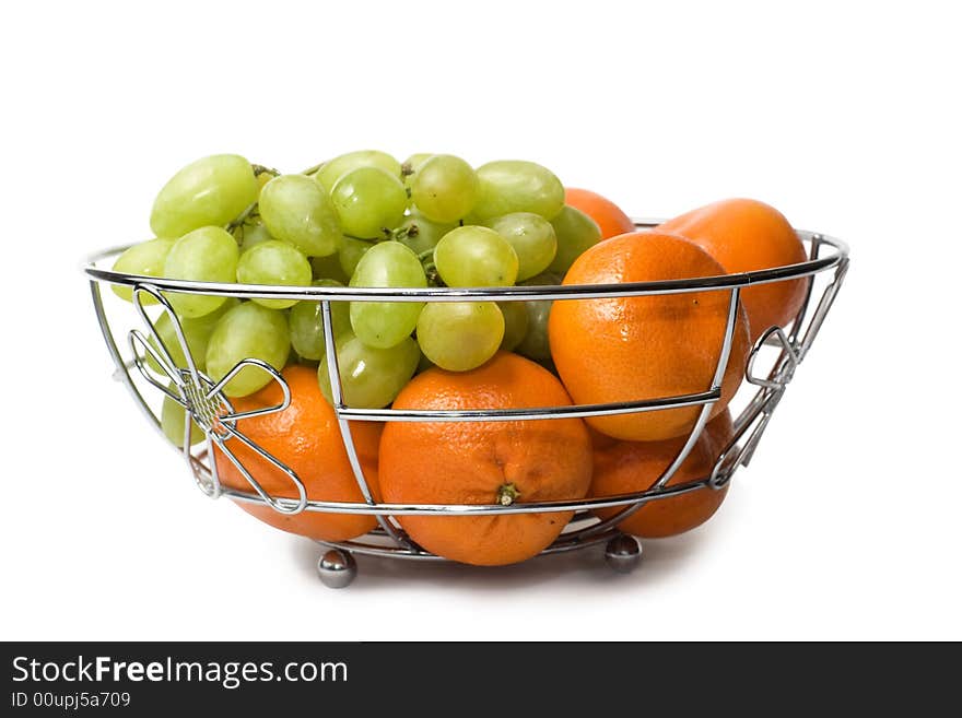 Tangerine and grape in vase. Tangerine and grape in vase