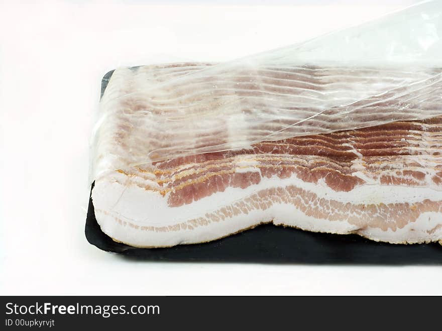 Slices of bacon in a plastic pack. Slices of bacon in a plastic pack..