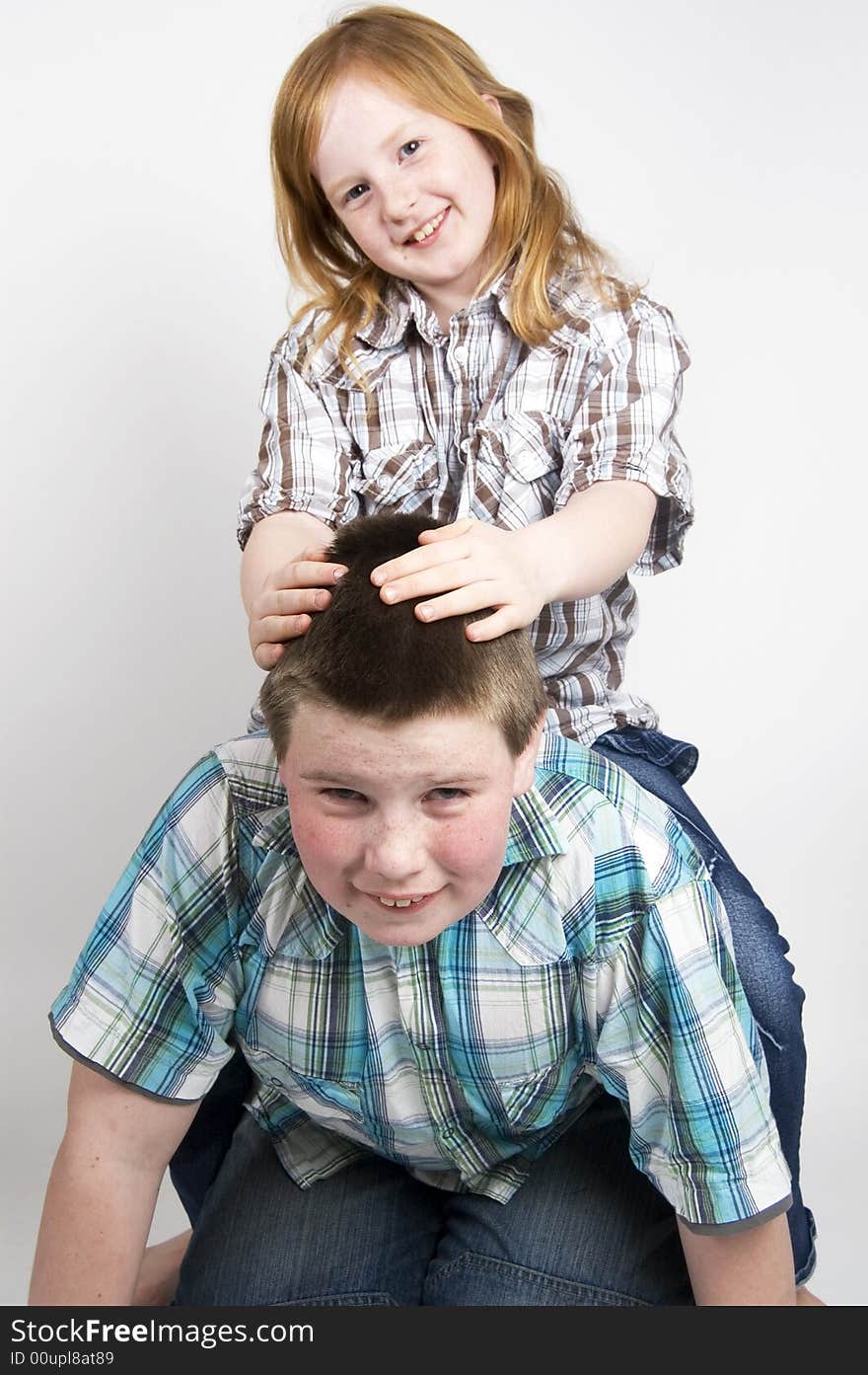 Brother and sister are happily teasing each other. Brother and sister are happily teasing each other