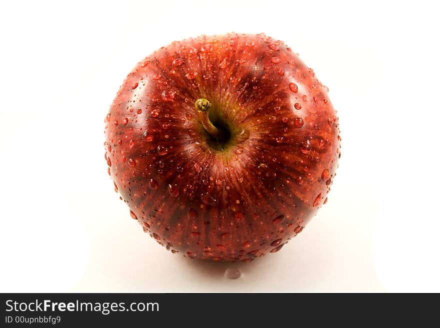 Red fresh apple with waterdrops isolated on white