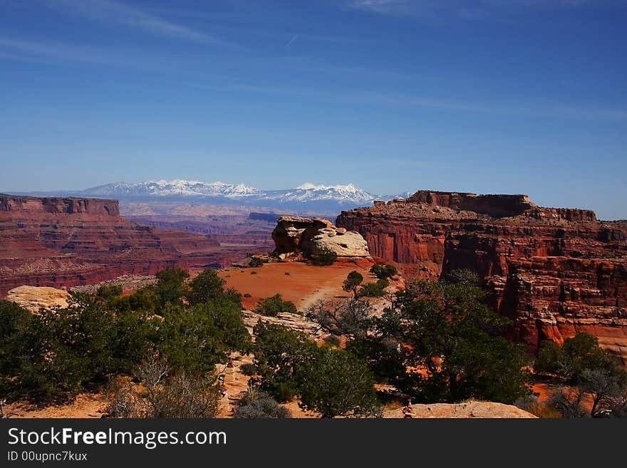 View of the red rock formations in Canyonlands National Park with blue sky�s and clouds. View of the red rock formations in Canyonlands National Park with blue sky�s and clouds