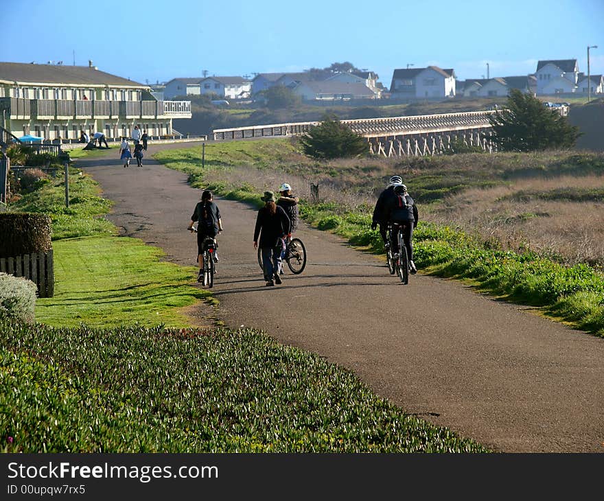 People using a nature path for walking, jogging, and biking. People using a nature path for walking, jogging, and biking