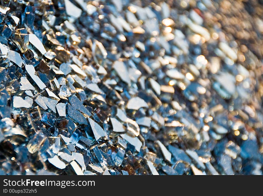 Shattered piles of glass compose an interesting abstract background. Shattered piles of glass compose an interesting abstract background