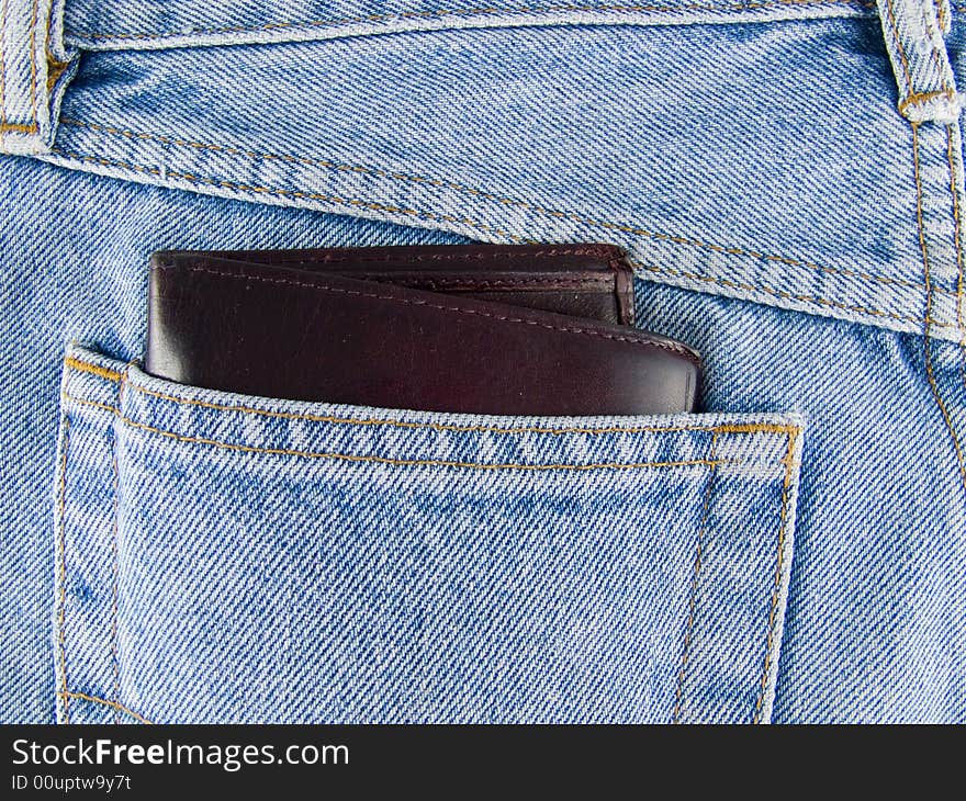 Jeans and brown leather wallet in pocket. Jeans and brown leather wallet in pocket